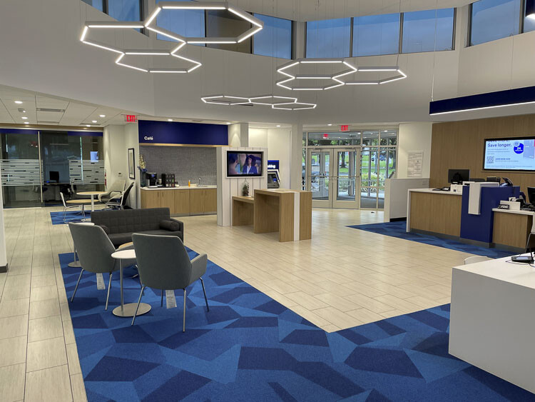 Modern US Bank branch interior with open floor plan, café area, and hexagonal lighting fixtures